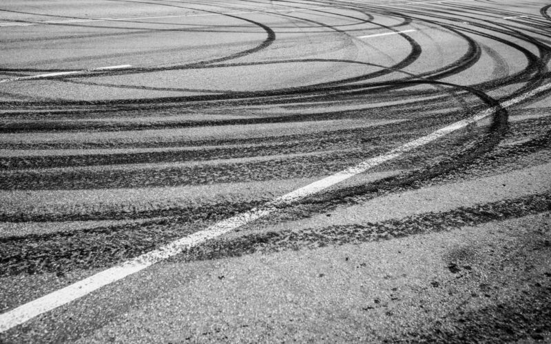 Photo of circular skid marks on a road.