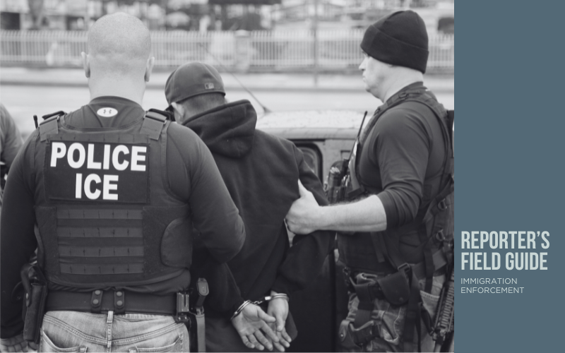 black and white photo of immigration officers arresting a man.