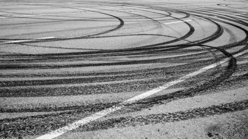 Photo of circular skid marks on a road.